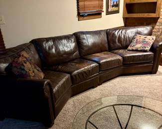 Curved brown leather sofa