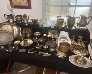TABLE FULL OF SILVER & METAL SERVING PIECES