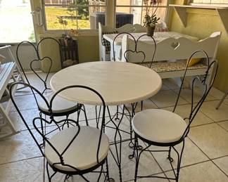 Wrought Iron Bistro Set with Heart Back Chairs and Amber Glass Oil Lamp