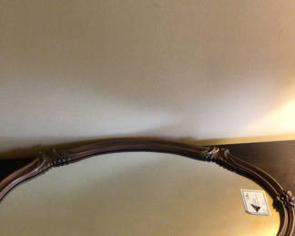 Lot 192: Ornate oval wooden-framed mirror