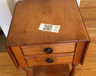 Lot 255: Two-drawer wooden end table with lower shelf
