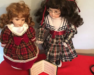 Lot 75: Two caroler dolls in plaid dresses with an open music book