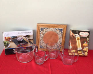 Lot 24: Glass measuring cups, digital scale box, and decorative tile art