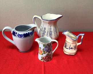 Lot 7: Assorted ceramic pitchers and a floral mug