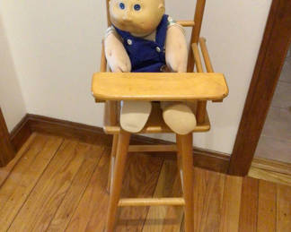 Lot 177: Wooden high chair with a doll