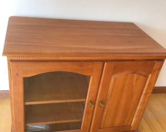 Lot 194: Wooden cabinet with glass-front left compartment and solid right door