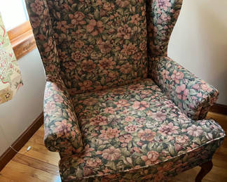 Lot 218: Floral patterned wingback armchair and small oval footstool