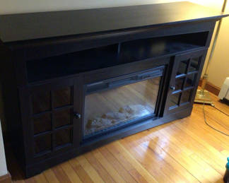 Lot 148: Dark Wood Fireplace Console with Built-in Fireplace and Glass Cabinets