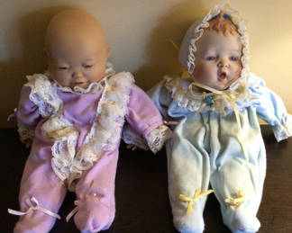 Lot 173: Two pastel-clothed cloth dolls with lace trim