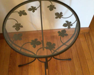 Lot 254: Round glass-top metal end table with ivy leaf motif