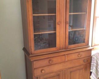 Lot 202: Wooden china cabinet with glass-front upper section and lower storage
