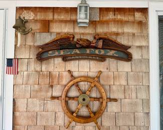 Nautical Decorations (sold as a set): wood and brass ship’s wheel; wood “Sea Fox”  Nantucket carved sign; brass bell; nautical lantern