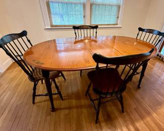 Vintage solid wood dining table with four matching chairs; extender stored underneath; heavy; slight wear