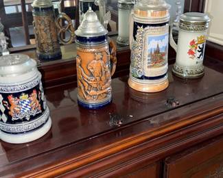 Collection of German Beer Steins with City and Heraldic Designs