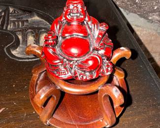 Red Laughing Buddha Figurine on Wooden Stand