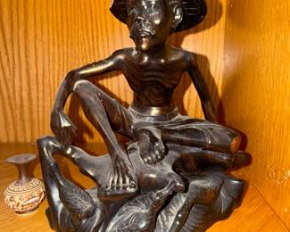 Carved Wooden Figure of a Seated Man with a Hat and Waterfowl Base