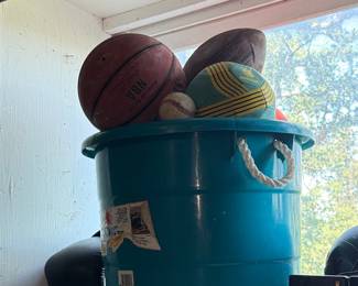 Collection of Sports Balls in Teal Bucket with NBA Basketball