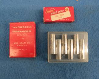 Lot 156. Three tuning tools: Wm. Kratt Co. "Synchrotone" violin-mandolin pitch pipe. Wm. Kratt Dulcimer Super Pitch Pipe. Japan six-tone pitch pipe.