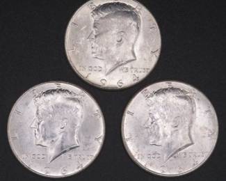 Lot 242. Three Kennedy 1964 Half Dollars that came to us in an unopened bank roll.