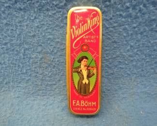 Lot 250. New old stock F.A. Bohm 10-hole harmonica and tin box in the key of C.