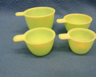 Lot 21. Jadeite measuring cup set. Includes 1 cup, 1/2 cup, 1/3 cup, and 1/4 cup.