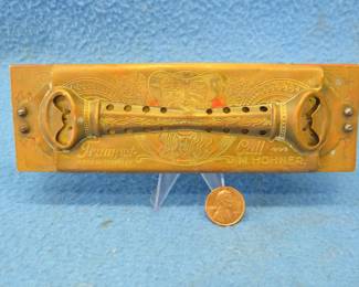 Lot 337. M. Hohner Trumpet Call harmonica. " Oriental Beauty" with old man motif. Minimum bid $50.