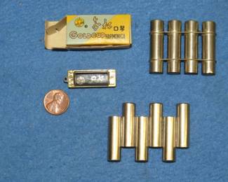 Lot 106. 1 3/8" mini 4-hole O.K. Gold Cup harmonica and the box and two pitch pipes