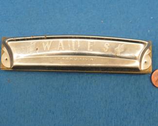 Lot 54. Unknown maker of a Wales 14-hole tremolo harmonica in the key of C made in Poland. In this auction's 'Auctioneer's Notes,' we list John Whitman's Harmonica Anthology 11th Ed. April 25, 2019 as a free and easy source to get more information about specific harmonicas. The harmonica in this lot or one like it can be found at page 612.
