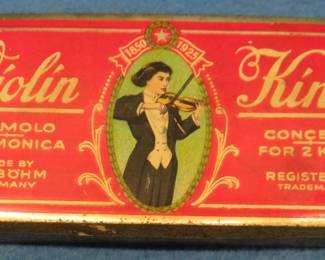 Lot 56. Vintage F.A. Bohm Violin King double-sided 64-hole harmonica with the hinged metal box. Poor sound.