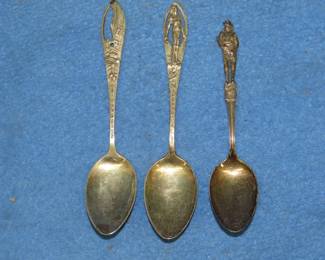 Lot 285. Three sterling silver spoons: Adirondacks with a deer scene. Niagara Falls with an Indian Brave. E Pluribus Unum with a Soldier. Total weight of 46.70 grams.