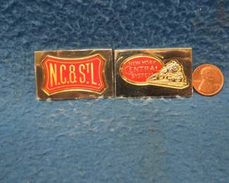 Lot 313. Two sterling silver ingots from "The Great American Railroad Emblems" series. The New York Central and the Nashville Chattanooga & St. Louis. Total weight 46.60 grams.