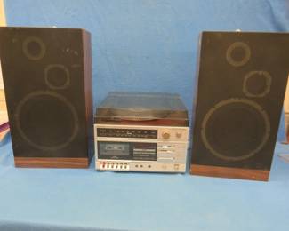Lot 353. Symphonic Model RPC-6015 entertainment center. Includes AM/FM receiver, cassette deck, two speakers, and a turntable. Powers up.
