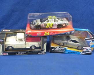Lot 328. Three Die-cast cars: NASCAR Jeff Gordon car. American Classics 1:24 scale 1955 Chevy 5100 Stepside. Fast & Furious Dom's Dodge Charger R/T.