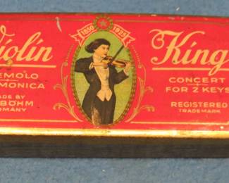 Lot 151. Vintage F.A. Bohm Violin King double-sided 64-hole tremolo harmonica with the hinged metal box both in VGC. Minimum bid $25. In this auction's 'Auctioneer's Notes,' we list John Whitman's Harmonica Anthology 11th Ed. April 25, 2019 as a free and easy source to get more information about specific harmonicas. The harmonica in this lot or one like it can be found at page 37.
