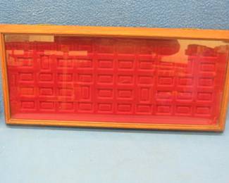 Lot 322. Display case for the sterling silver emblems previously listed. The rest of the emblems will be sold at the next auction.