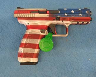 Lot 339. Canik TP9SF 9mm semi-auto pistol with American flag motif. Never been fired. S/N T6472-22AT09455. Ducks Unlimited Edition. Includes hard case, Kydex holster, manual, two magazines, extra backstrap, speed loader, and cleaning brush.