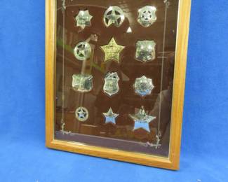 Lot 25. Set of 12 Franklin Mint sterling silver Badges of the Great Western Lawman in a hinged wooden display case. 231 grams of sterling. Excellent condition.