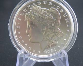 Lot 185. Uncirculated high grade and encapsulated 2021 S Morgan Silver Dollar with 99.9% silver, a silver weight of .858 of a troy ounce, and a certificate of authenticity from the US Mint