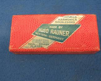 Lot 209. Vintage Hugo Rauner 64-hole double-sided tremolo harmonica with brass reeds in the keys of C and G. Sounds great. Harmonica and box are in excellent condition. In this auction's 'Auctioneer's Notes,' we list John Whitman's Harmonica Anthology 11th Ed. April 25, 2019 as a free and easy source to get more information about specific harmonicas. The harmonica in this lot or one like it can be found at page 436. Minimum bid $40.