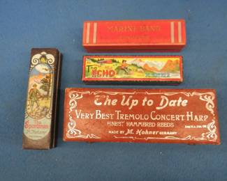 Lot 252. Four old harmonica boxes: Wooden hinged 7 5/8" M. Hohner The Up to Dater Very Best Tremolo Concert Harp. M. Hohner 5" box with original wrapping paper inside. M. Hohner 5" The Sportsman box in like new condition. M. Hohner 5" The Echo box in like new condition.