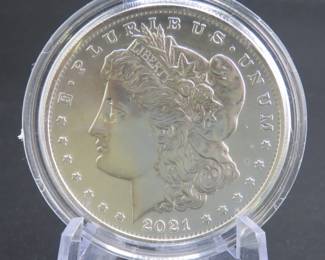 Lot 186. Uncirculated high grade and encapsulated 2021 O Morgan Silver Dollar with 99.9% silver, a silver weight of .858 of a troy ounce, and a certificate of authenticity from the US Mint