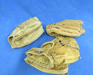 Lot 62. Reggie Jackson and Carl Yastrzemski baseball gloves, and a third unmarked glove