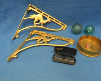 Lot 119. Collectibles including iron camel-themed shelf brackets, brass artillery shell bottom, old glasses, and Japanese fishing net floats