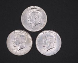 Lot 232. Three Kennedy 1964 Half Dollars that came to us in an unopened bank roll.