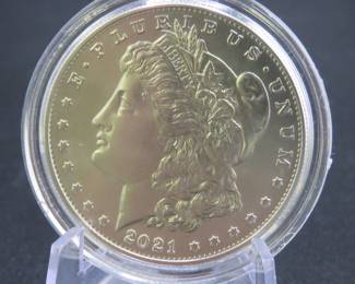 Lot 187. Uncirculated high grade and encapsulated 2021 CC Morgan Silver Dollar with 99.9% silver, a silver weight of .858 of a troy ounce, and a certificate of authenticity from the US Mint