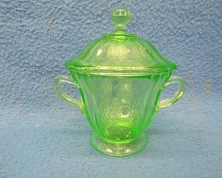 Lot 284. Green Depression uranium glass sugar bowl and lid with a parrot motif. Excellent condition.