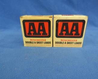 Lot 386. Two vintage AA shotgun shell boxes. Each box contains 25 mixed AA shotgun shells. These shells may be reloads. AS-IS. Use at your own risk.