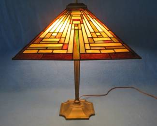 Lot 66. Faux stained glass lamp with a heavy metal base in excellent condition
