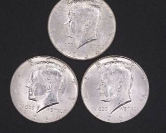 Lot 233. Three Kennedy 1964 Half Dollars that came to us in an unopened bank roll.
