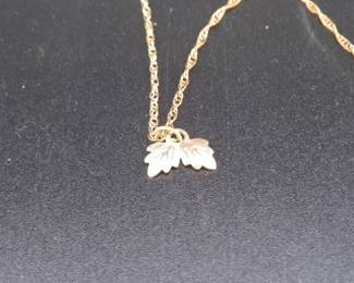 Lot 352. Gold necklace and pendant weighing 17.2 grains. The necklace clasp is marked 14k and the pendant it marked 12k.
